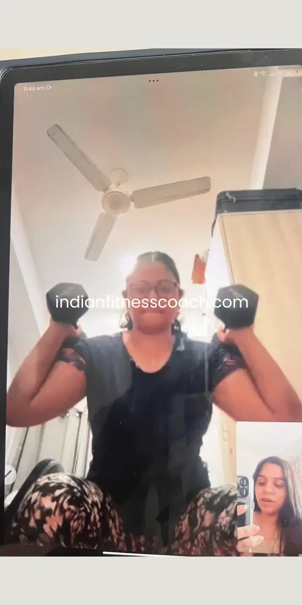 Client doing dumbbell thrusters during a live IFC training session