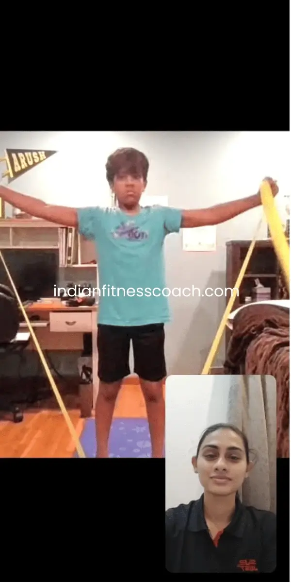 Client doing resistance band lateral raises during a live IFC training session