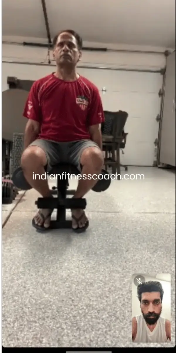 Client doing seated bicep curls during a live IFC training session